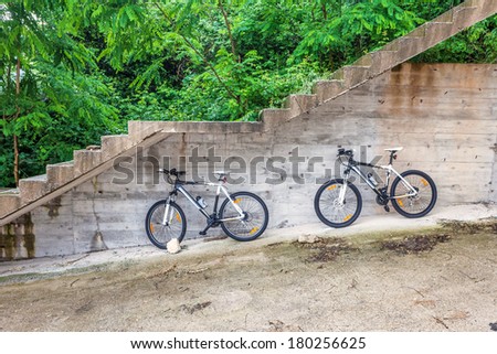 two bikes under the stairs to the mountain