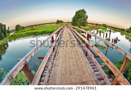 Wooden bridge over the small river. fisheye lens
