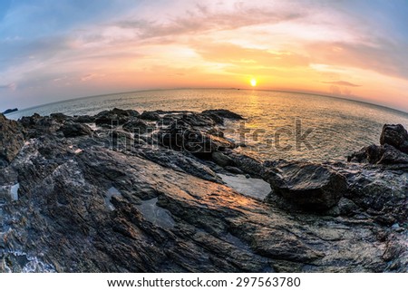 Panoramic view on sunset sea, small island, palms and boats  in fish-eye lens. Nature background