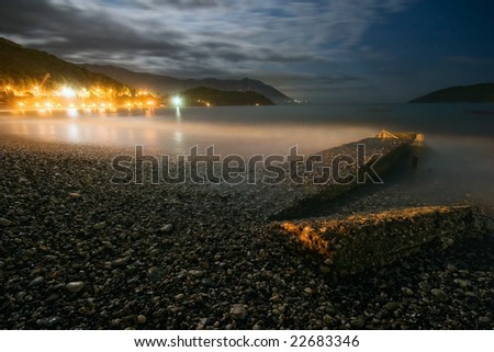 Night landscape with the sea, the moon and rocks. It is photographed in Montenegro in September 2007. The city of Budva. Adriatic sea.
