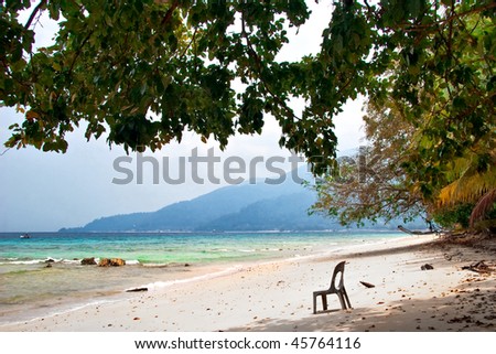 The old plastic chair thrown on the relax beach. Tioman island. Malaysia