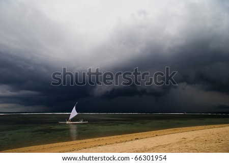 Sailboat on the horizon in bad weather