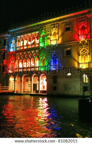 Beautiful water street at night time in color lights in Venice, Italy