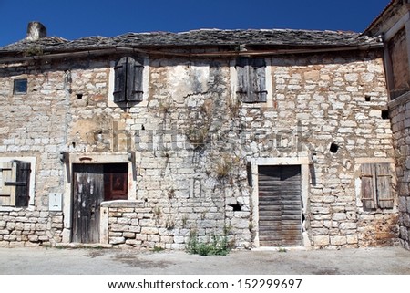 old damaged mediterranean house with sandstone walls landscape