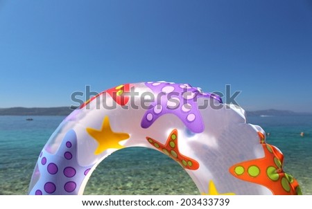 swim ring and beautiful blue sea and sky in the background