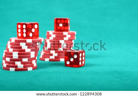 Poker gambling chips on a green playing table, stacks of poker chips , casino concept
