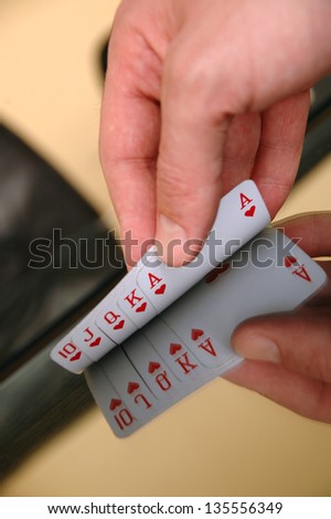 Gambling concept, human hand showing playing cards on the glass table