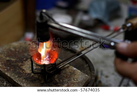 Jewelers manufacture. Melting silver in a small crucible for making jewelery
