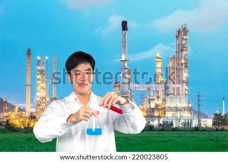 Investigator checking test chemical tubes with chemical factory background