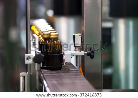 Syrup Bottles transfer on Conveyor Belt System