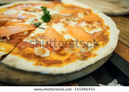 Smoked salmon pizza produces from wood fired oven.