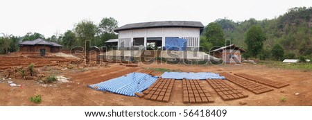 Under construction of thai \'mud house or Cob Cottage\' . Mud house is left side of picture.