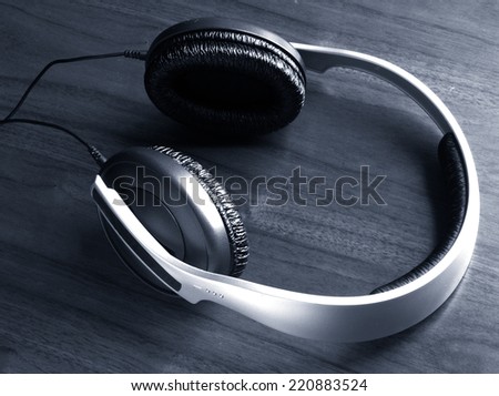 Headphones over wood monochrome image