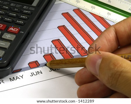 sales graph pen and hand