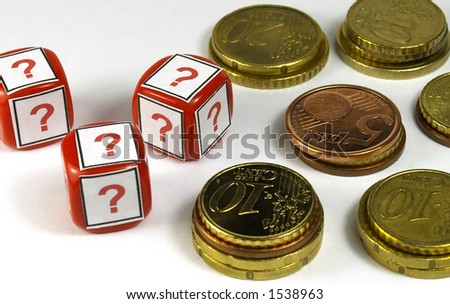 several euro coins and dice with question simbol printed