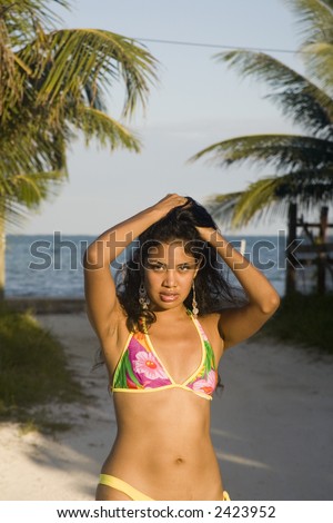 Young model at the beach in a seductive pose