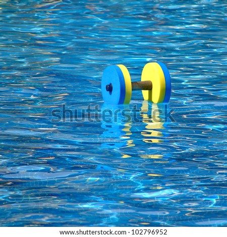 Floating aqua aerobics dumbbell in swimming pool
