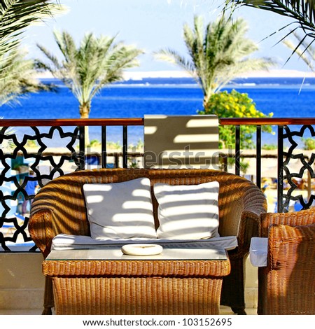 Villa terrace with wicker furniture and sea view
