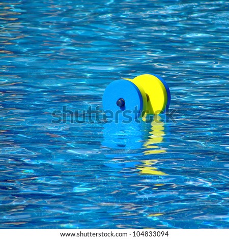 Floating aqua aerobics dumbbell in swimming pool