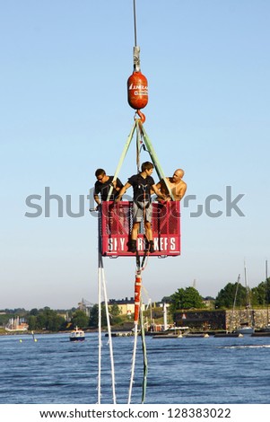 HELSINKI, FINLAND - JULY 27: Bungee jumping from a crane on July 27, 2012 in Helsinki. The height of the jump is 150 meters, the speed gained during a jump is about 120 km/h