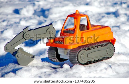 Toy excavator on the snow