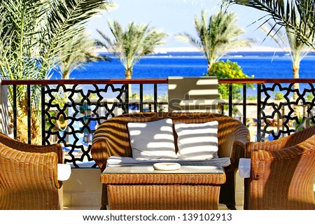 Villa terrace with wicker furniture and sea view