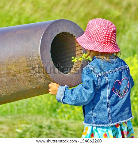 Little girl, gun and yellow flowers. Old Russian Cannon in Suomenlinna Sveaborg Helsinki Finland