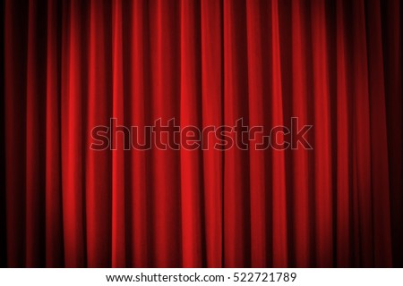 A red stage curtain with vignette light