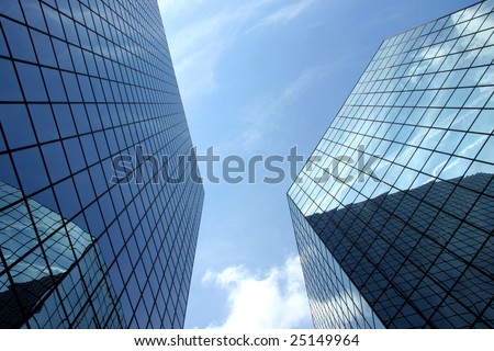 A upward perspective of two very modern skyscrapers