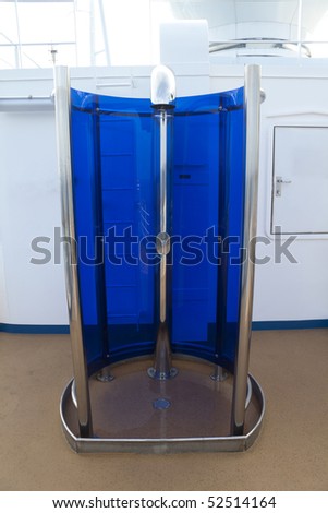 An outdoor shower surrounded by blue glass