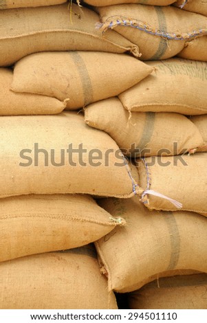 Stack hemp sacks of rice in the warehouse,stacked in a row to keep up.