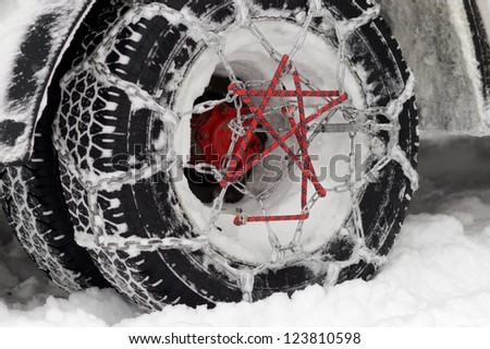Light truck winter tire whit mounted chains.