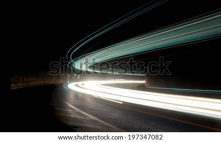 Truck and car light trails in tunnel. Art image . Long exposure photo taken in a tunnel