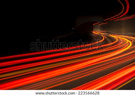 Abstract trails red, yellow and  rays of light in a car tunnel