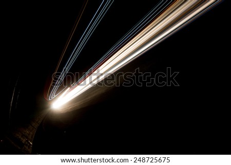 Abstract yellow and white rays of light in a car tunnel
