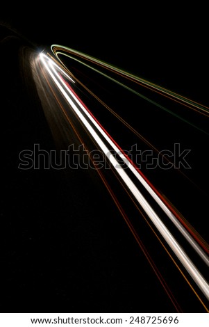 Abstract white rays of light in a car tunnel