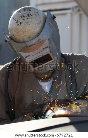 welder at shipyard working on steel project
