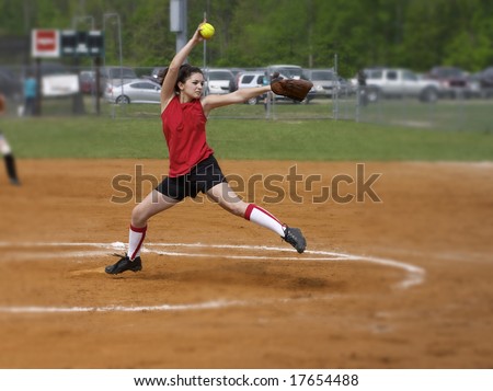 a fastpitch softball player pitching the windmill