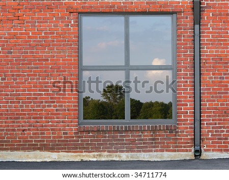 view of blue sky and clouds through a window in brick wall