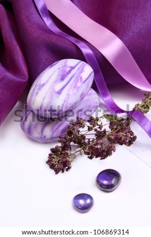 Aromatic soap with herbs and purple decorative fabric