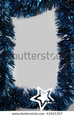 Blue Christmas ornaments frame with silver star and light-gray background