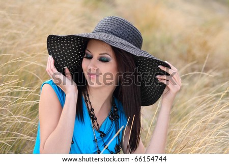 Portrait of a young cheerful girl in stylish bonnet