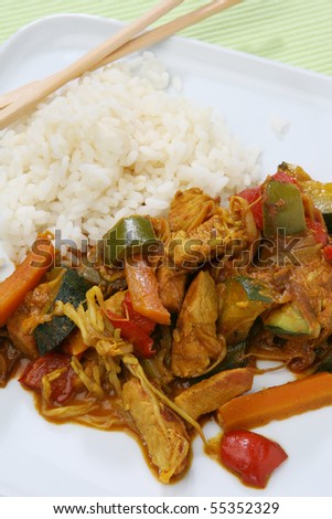 Wok food Asia with carrots, pumpkin, chicken, germs, paprika and rice