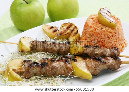 Pork sticks barbecue with rice salad germs and apples
