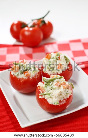 Stuffed tomato with rice, mayonnaise dressing and vegetables