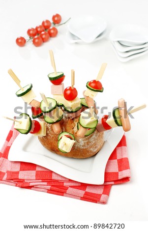 A bouquet of various vegetables , cheese, and small sausage dish for a party