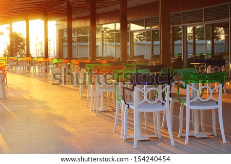 Evening at hotel restaurant with multiple colorful chairs