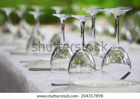 Many served wine glasses on the table turned upside-down