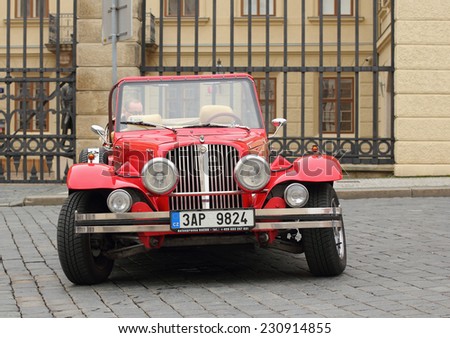 Prague, Czech Republic - November 9, 2014: Red Alfa-Romeo retro car waiting for the next customer to entertain. These cars are usually rented by the tourists visiting Prague.