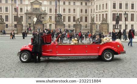 Prague, Czech Republic - November 9, 2014: The driver opening a hood and looking inside the car, checking if everything is good with the touristic car. Central square of Prague